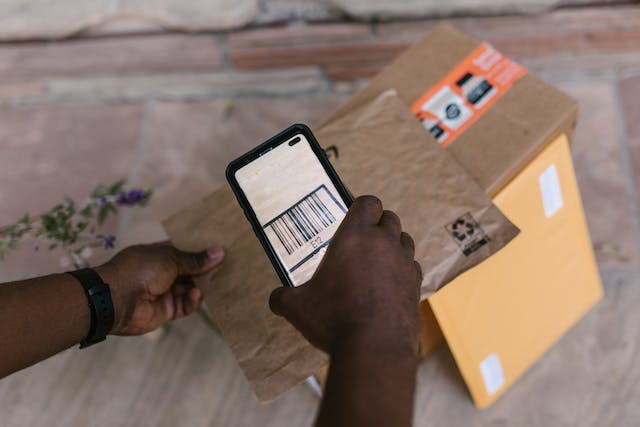 person taking picture of barcode on package
