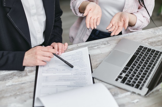 two people discussing over a contract