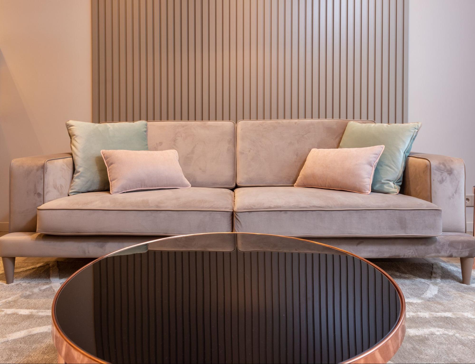 Living room with gray couch and a round brown table