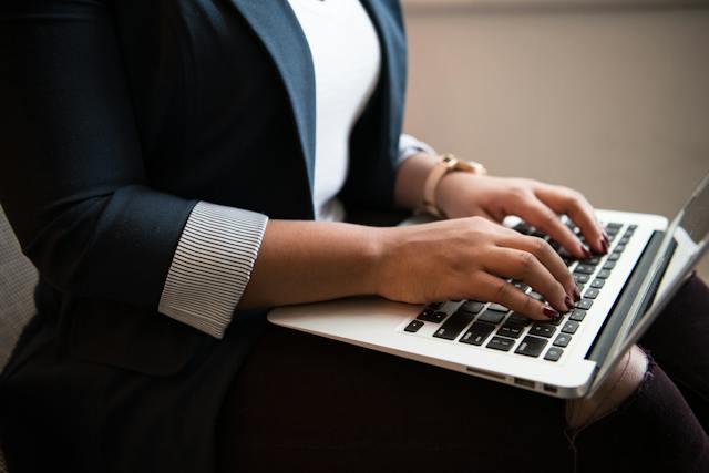 pair-of-hands-typing-on-a-laptop